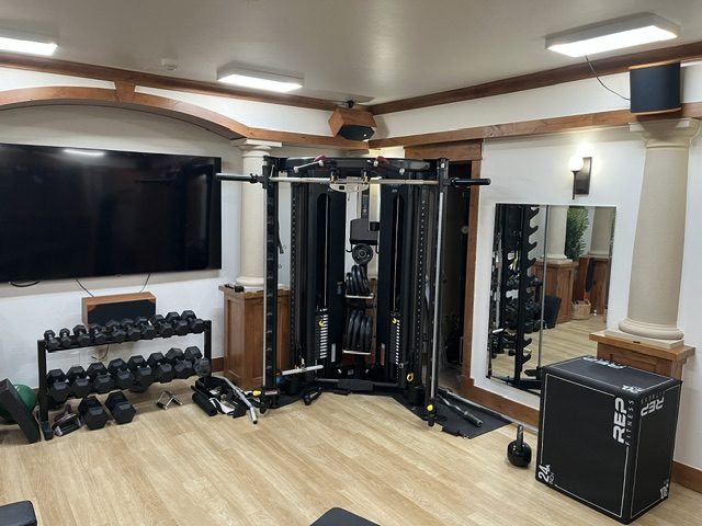 Functional trainer and free-weight area under a coffered ceiling