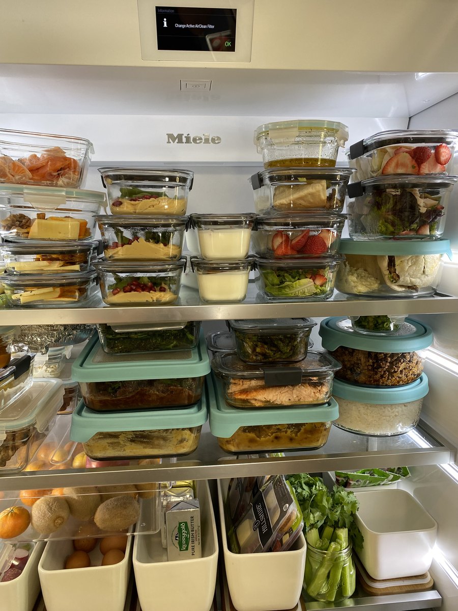 A week of prepared meals in glass containers filling a fridge